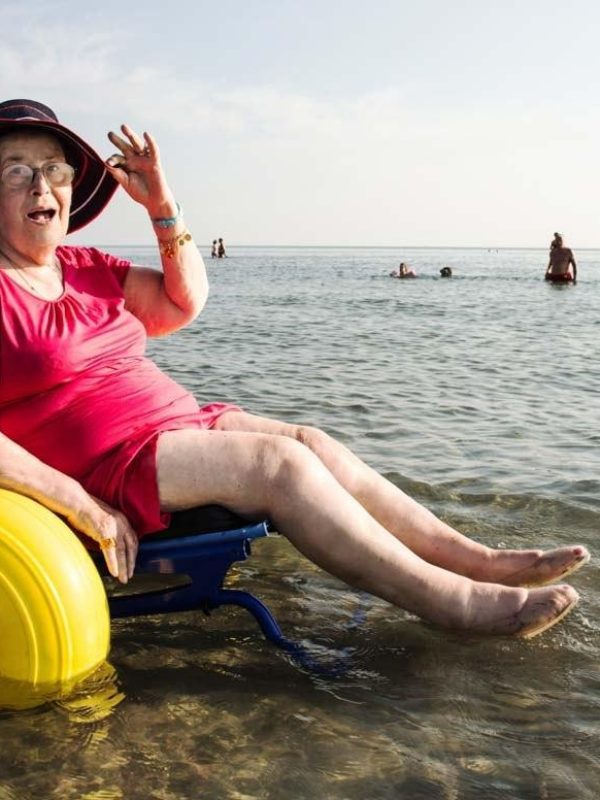 Senior lady on a special wheelchair for the beach